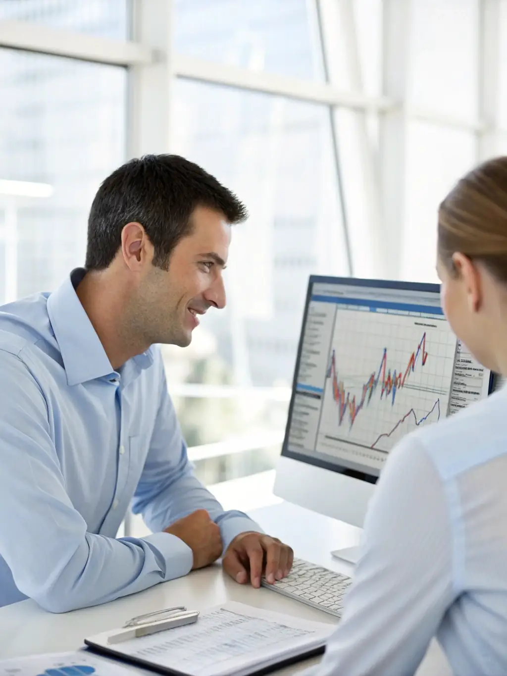 A professional business consultant in a suit reviewing financial charts and payment solution options with a client in a modern office setting, conveying trust and expertise for a consulting website.